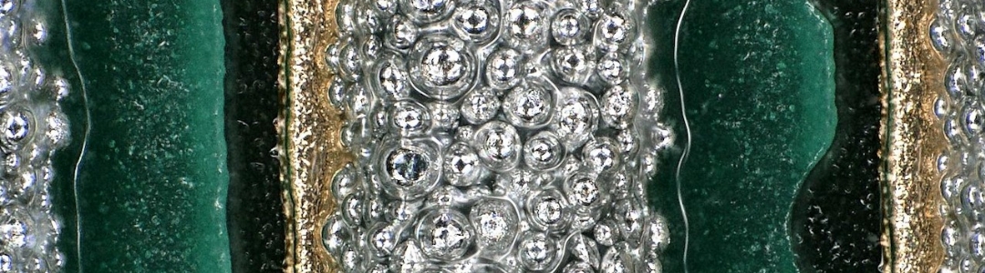 Extrem nah aufgenommene Lotpaste, in der die vielen feinen Metallkugeln deutlich sichtbar sind